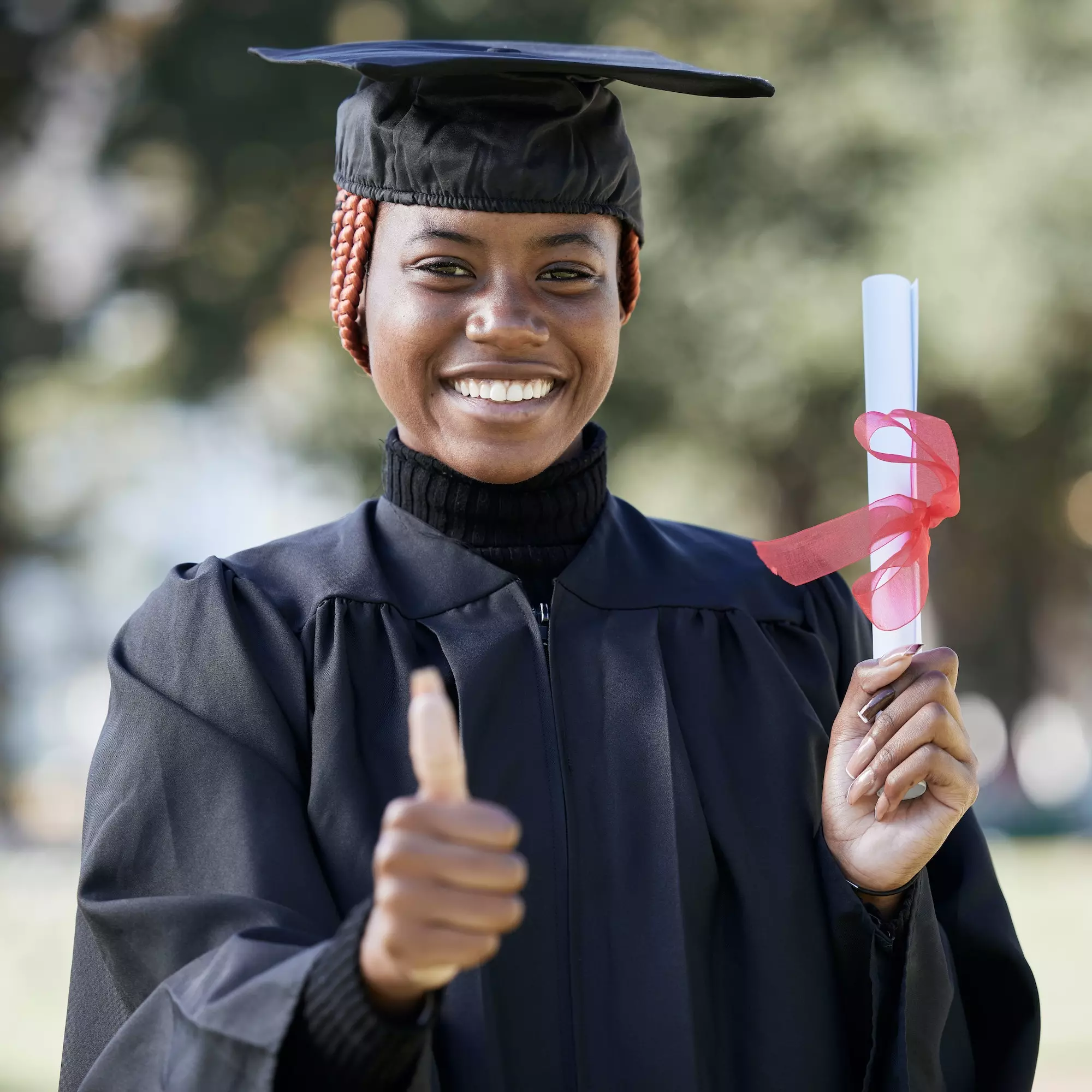 Portrait, black woman and thumbs up for graduation, education and success with degree. African Amer